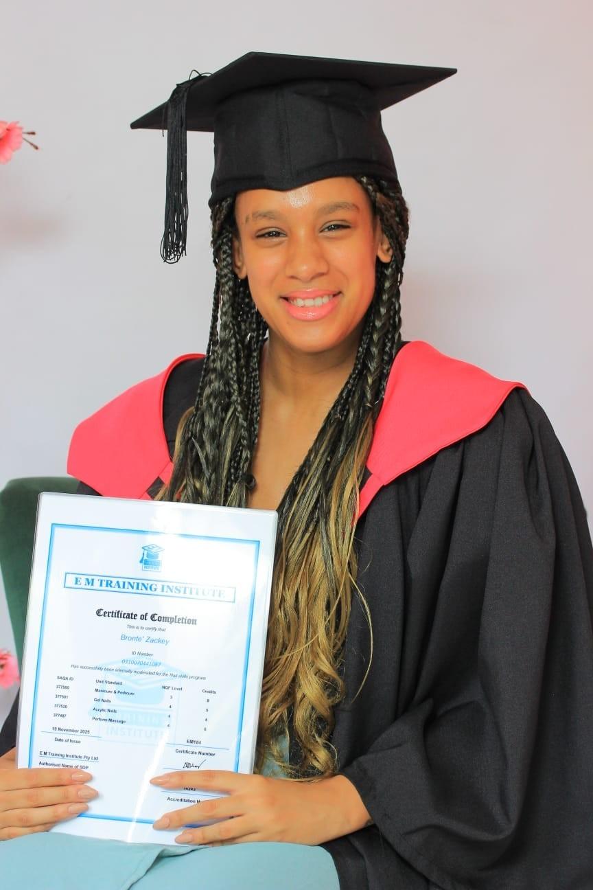 Graduate holding an E M Training Institute certificate
